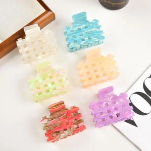 Detailed set of six marble-textured acetate hair claws with geometric cutout designs