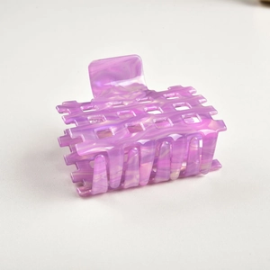 Detailed macro view of the purple marble acetate hair claw with hollow square grid design
