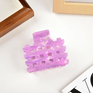 Detail of purple marble acetate hair claw clip with hollow square design and smooth texture