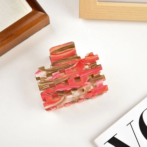 Detail of hollow square acetate hair claw clip with brown marble pattern texture