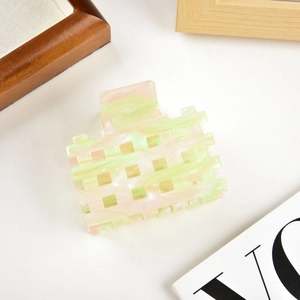 Detail of hollow square hair claw clip with pink and green marble acetate texture