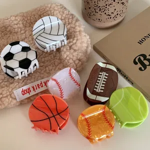 Variety of sports-themed hair claws featuring basketball, football, and tennis designs