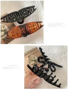 Detail of large resin butterfly hair claw clips in black and tortoiseshell finish