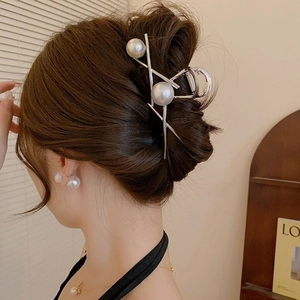 Elegant silver metal shark hair claw with large pearls shown on woman's updo hairstyle