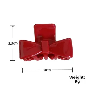 Detailed view of red bow hair claw clip showing 4cm width and 2.3cm height dimensions