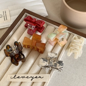 Set of minimalist acetate bow hair claws in various marble colors and patterns