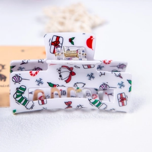 Détail de la pince à cheveux de Noël avec motifs festifs et mécanisme à ressort