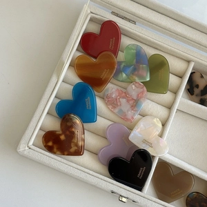 Assorted heart-shaped acetate hair clips with leopard print and marble textures in a gift box