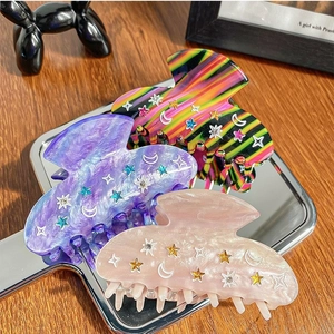 Three-piece acetate hair claw clips with star moon patterns and sparkling rhinestones