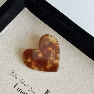 Close-up of heart-shaped tortoiseshell hair clip with gold France Handmade logo