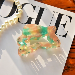 Detailed shot of marbled acetate star hair claw clip with rhinestones and elegant texture