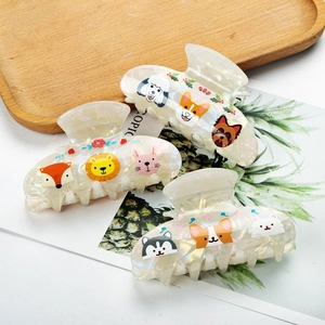 Three large animal print hair claws with pearlescent finish for stylish buns