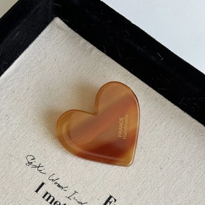 Close-up of heart-shaped leopard pattern hair clip with France Handmade engraving