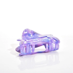 Detail of marbled purple and blue acetate hair claw clip with rhinestones