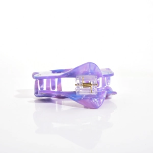 Detailed view of marbled purple and blue acetate hair claw clip with golden metal spring