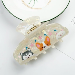 Close-up of hair claw clip with animal prints, resin texture and sturdy gold metal spring