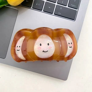 Pinza para el pelo de acetato con carey marrón y tres caritas sonrientes blancas