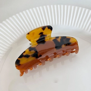 Close-up of tortoise shell pattern hair claw clip with a dark brown heart decoration