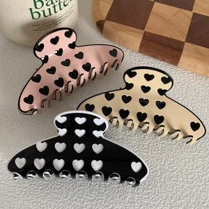 Three-piece acetate heart print hair claws in pink, beige, and black for women