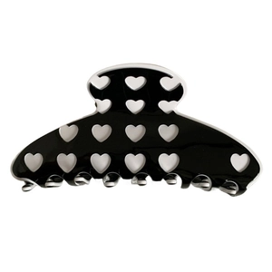 Large black heart-patterned hair claw clip with white cut-outs for stylish hair styling