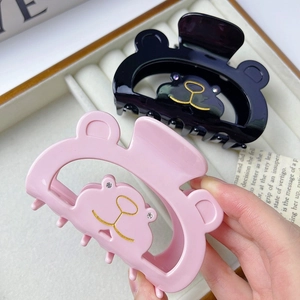 Pinces à cheveux en forme d'ours rose et noir avec des yeux en strass et détails dorés