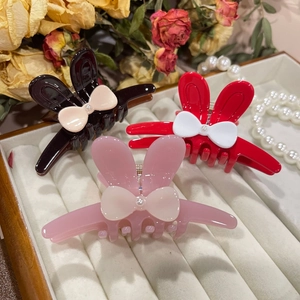 Elegant rabbit ear hair claws with cream bows and pearls in black, red, and pink colors