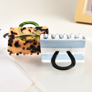 Elegant handbag-shaped acetate hair claw clips with tortoise and striped patterns