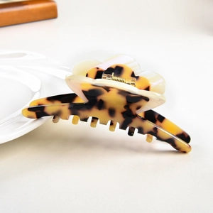 Macro view of floral acetic acid hair claw clip with tortoise leopard pattern texture