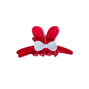 Red rabbit ear hair claw clip with white bow and faux pearl detail on white background