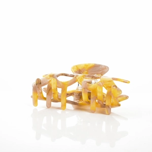 Detailed view of large marble texture acetate hair claw clip with cross teeth on mirror base
