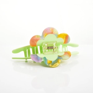 Close-up of a large green floral hair claw clip with colorful dreamy candy tones