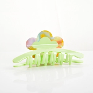 Detail of large acetate hair claw clip with colorful marble wave design and strong metal spring