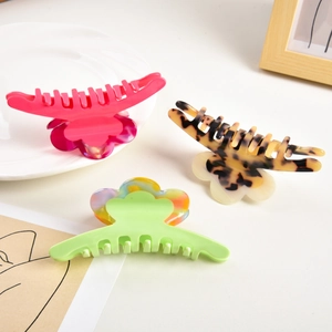 Three floral acetate hair claws in pink, leopard, and marble patterns for women hair styling