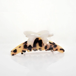 Detail of tortoise shell butterfly hair claw clip with vintage acetate patterns