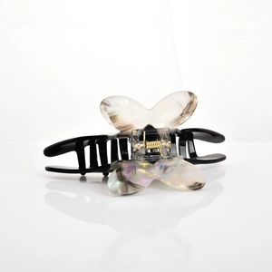 Macro detail of a large marble butterfly hair claw clip with black polished finish