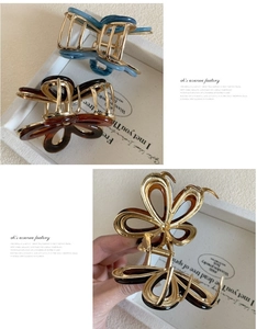 Detailed view of acetate flower hair claws in amber and blue marble textures