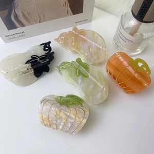 Elegant pumpkin-shaped acetate hair claw clips with shimmering pearlescent finish