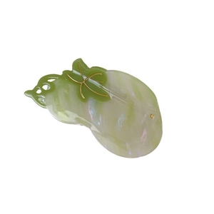 Elegant pumpkin shaped hair claw clip in pearlescent green acetate with golden accents
