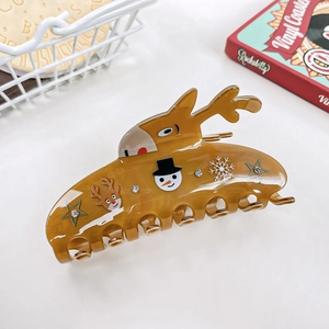 Detail of Christmas reindeer claw clip with snowmen patterns and small rhinestones