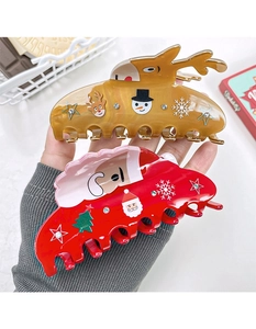 Detailed view of festive reindeer and Santa hair claws with rhinestones and holiday patterns