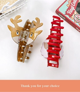 Close-up of brown reindeer hair claw and red shark clip in a festive gift basket