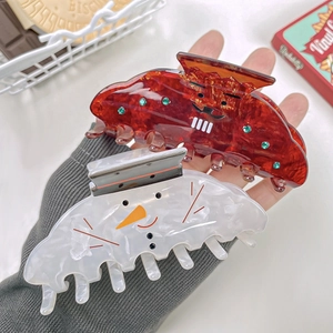 Cute Christmas hair claws with reindeer and snowman designs for festive styling