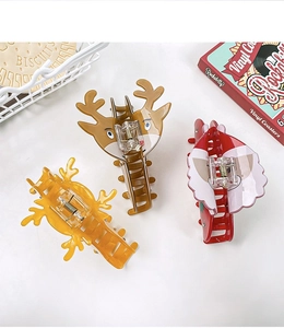 Three-piece Christmas hair claw set with reindeer and Santa designs on white background