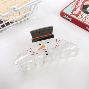 Close-up of a white snowman hair claw clip with black top hat and red scarf detail