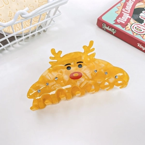 Detailed view of yellow reindeer hair claw clip featuring sparkling white rhinestones