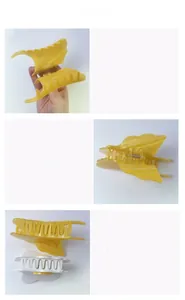 Detailed view of yellow and white acetic acid butterfly hair claws with metal spring