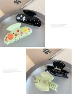 Detailed views of acetate hair claws featuring star rhinestones and fresh lemon patterns