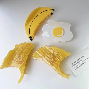 Ginkgo leaf and food shaped acetate hair claws in yellow banana and egg designs