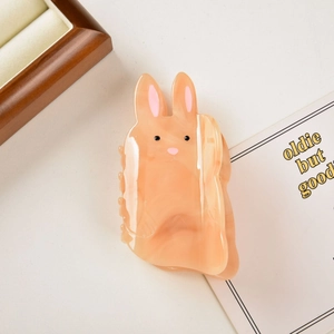 Detail of cute rabbit hair claw clip made of pink marble acetate with a soft texture