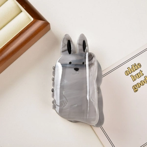 Close-up of cute rabbit-shaped hair claw clip with grey marble texture acetate finish